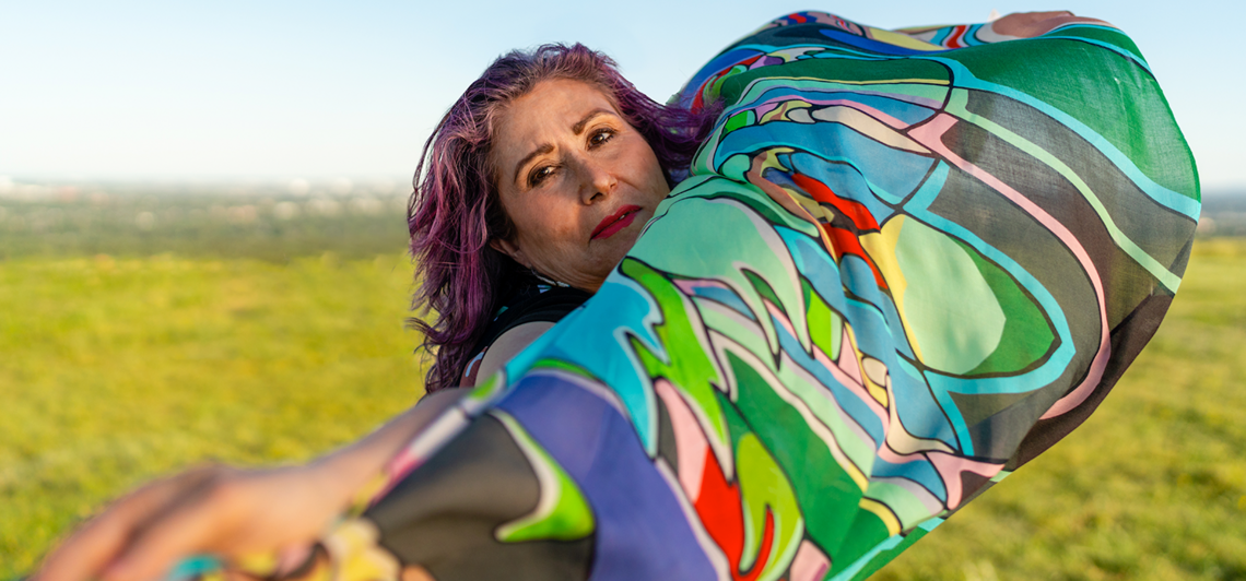 Samaria Cardinal holding fabric on Calgary's Nosehill park