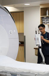 A member of the Stephenson Cardiac Imaging Centre team prepares the CMRI