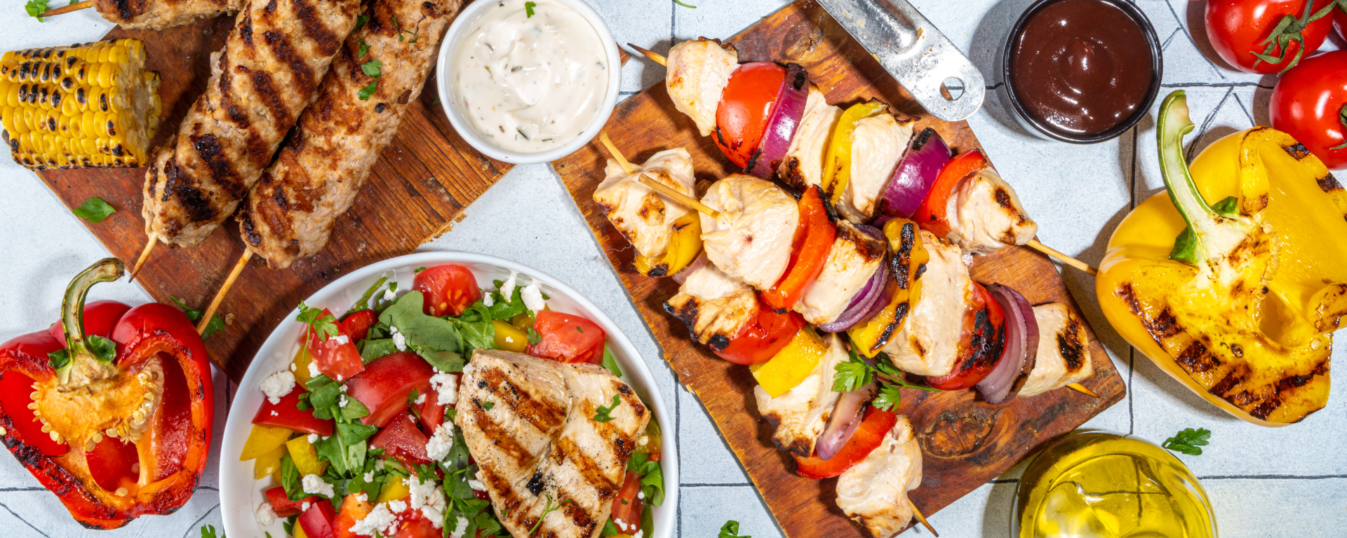 summer BBQ spread of grilled vegetables, meat and salads 