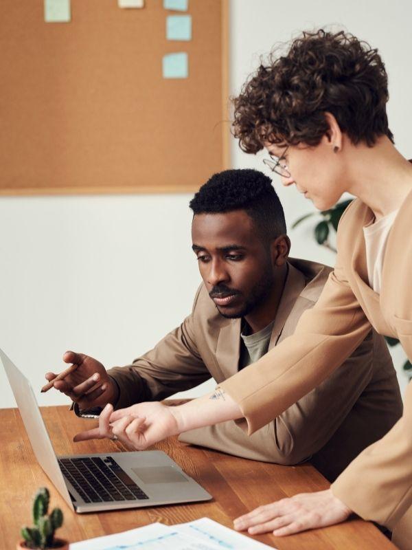 two people working on a lab top