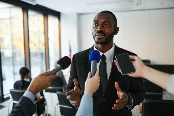 man speaking to the media