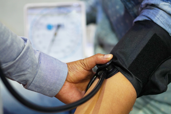 a doctor checking a patient's blood pressure