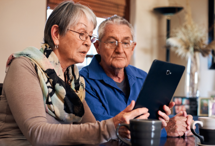 senior couple looking at an ipad