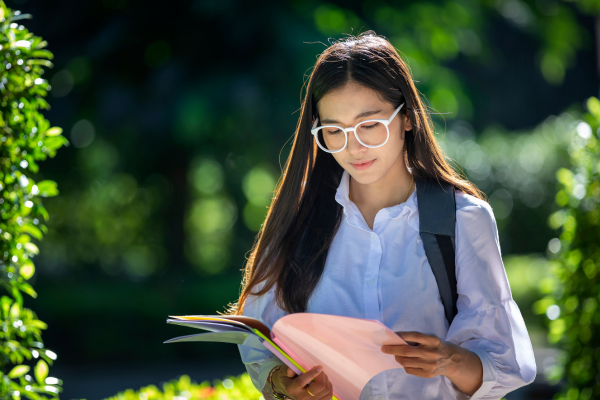 young woman reading outdoors