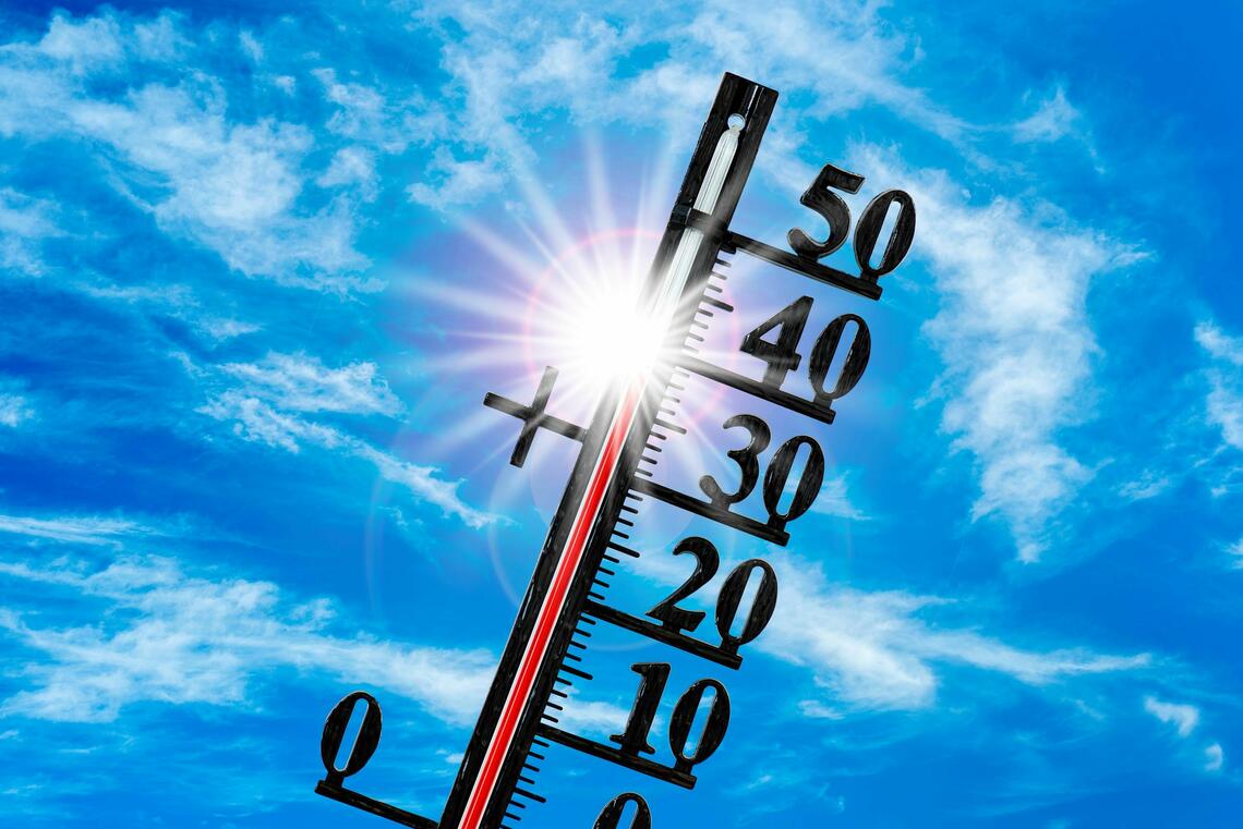 thermometer showing high temperatures set over blue sky
