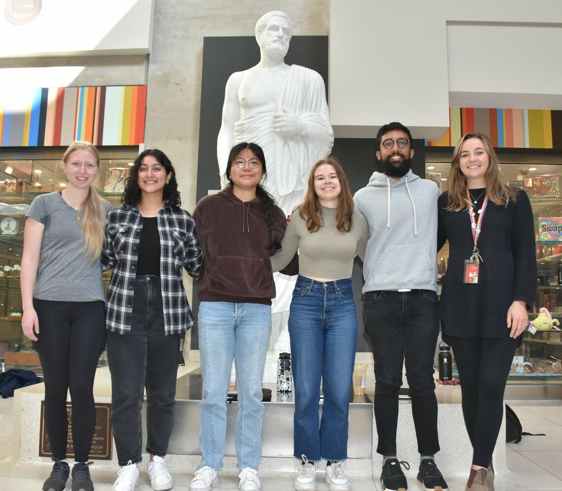 Members of the 2023-2024 LCITO Executive team stand in front of a statue