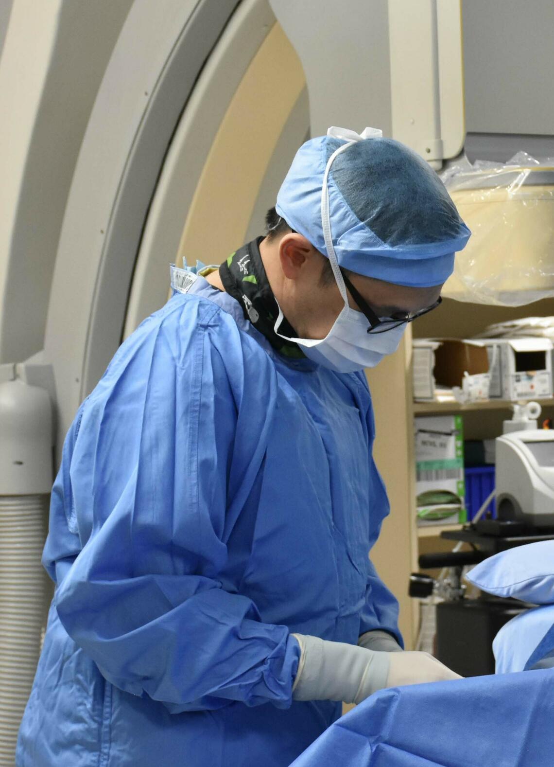 Dr. Bryan Har performing a procedure on a patient in the cath lab Dr. Bryan Har performing a procedure on a patient in the cath lab