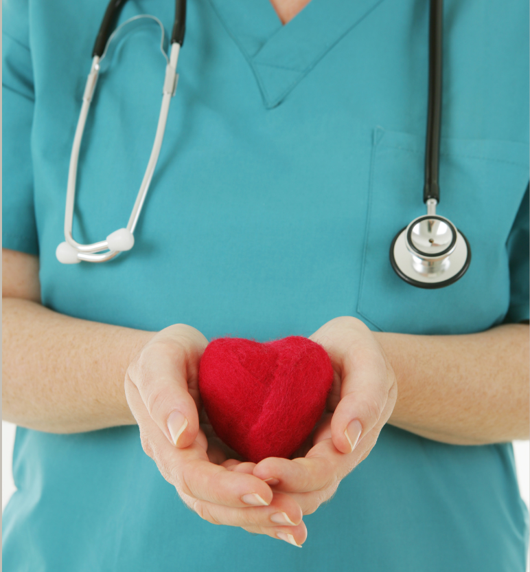 Nurse in teal scrubs holding a red heart