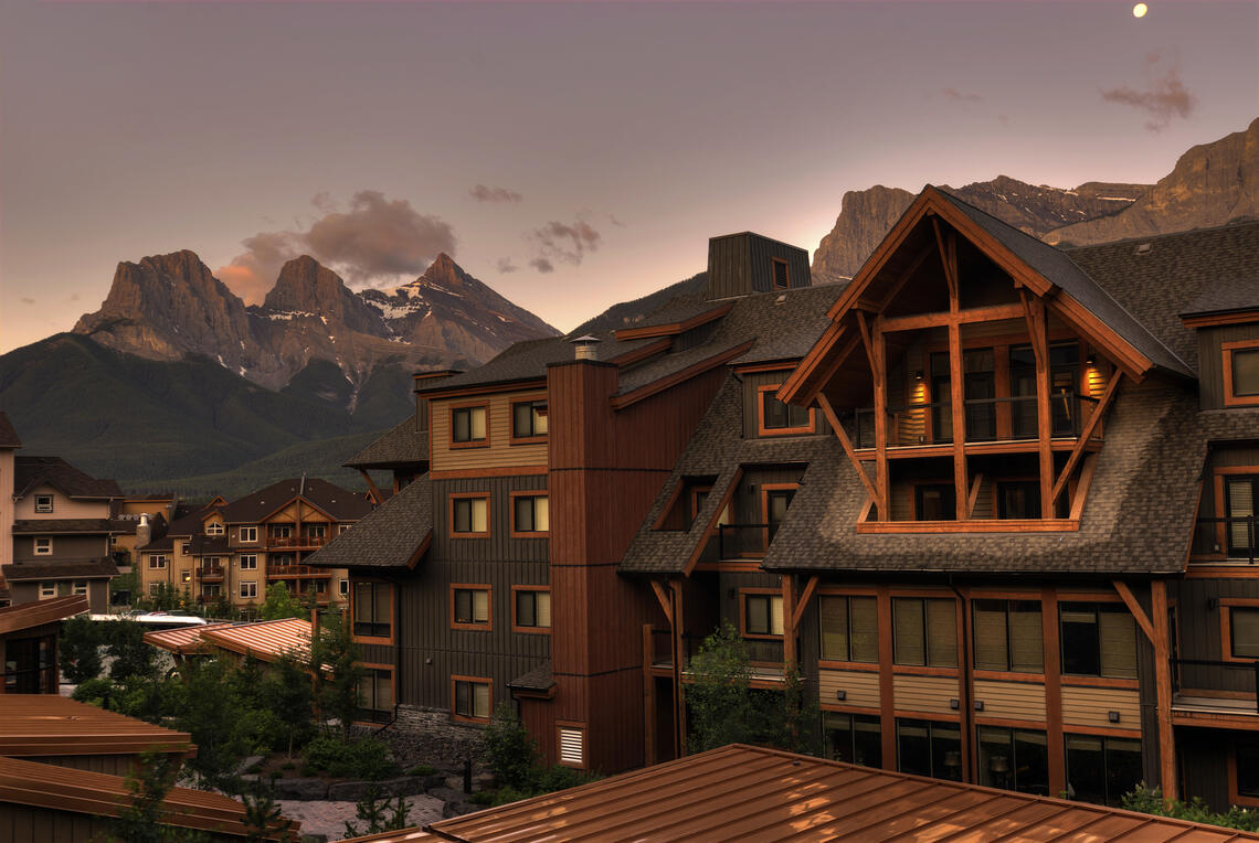 A building in Canmore, Alberta with mountains in the background
