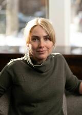 Dr. Claire Allen poses for a photo in front of a window