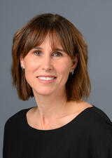 Dr. Jennifer Thompson poses for a photo wearing a black shirt 