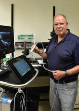 A man stands in front of scientific devices