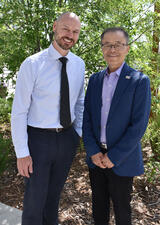Dr. Dave Campbell and Dr. Hude Quan pose for a photo outdoors