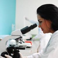 researcher using a microscope